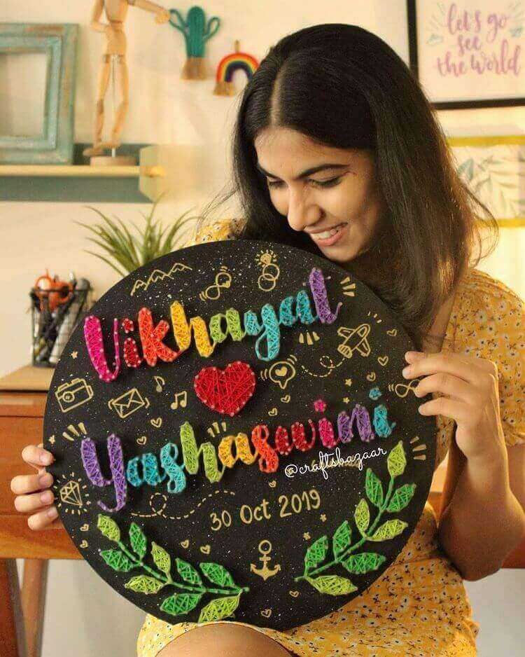 Muskan Rajpur, craft bazaar string artist holding her string art Couple's name string art made my string artist Muskan Rajput on a canvas.